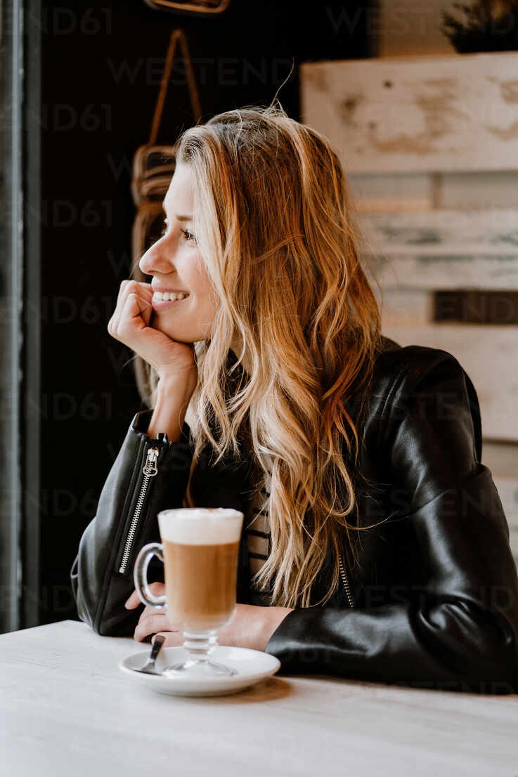 files/side-view-of-long-haired-trendy-beautiful-blonde-woman-sitting-in-a-cafe-shop-drinking-from-a-glass-of-delicious-foamy-coffee-ADSF10876.jpg